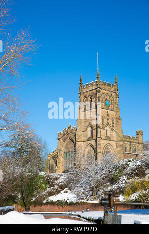 St. Mary's Church, Kidderminster, UK, on a bright sunny morning with snow on the ground & bright, blue sky. Picturesque winter scene. Portrait format. Stock Photo