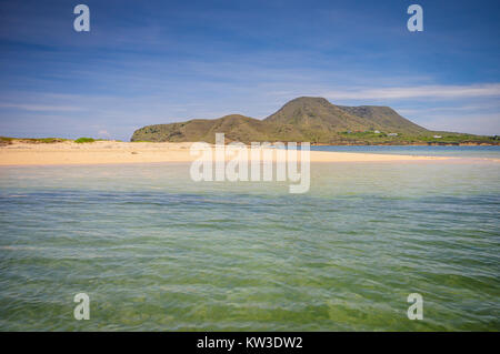 Calm ocean shore at base of mountain at Monte Cristi National Park in Monte Cristi, Dominican Republic. Stock Photo