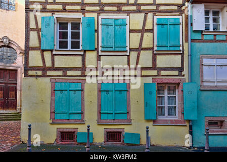 Blue windows on pale yellow walls of a small town Stock Photo