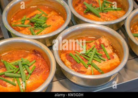 Vibrant red Korean Kimchi soup, with green onions on the top, in Namdaemun Market, Seoul, South Korea Stock Photo