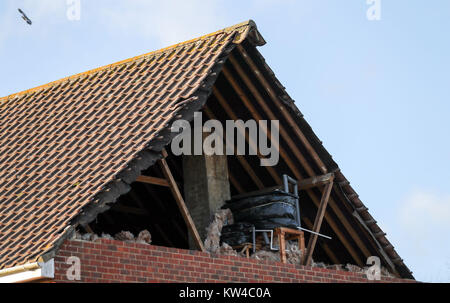 A view of damage to the gable end of a house in East Boldre, Hampshire, after strong winds hit on Friday. Stock Photo