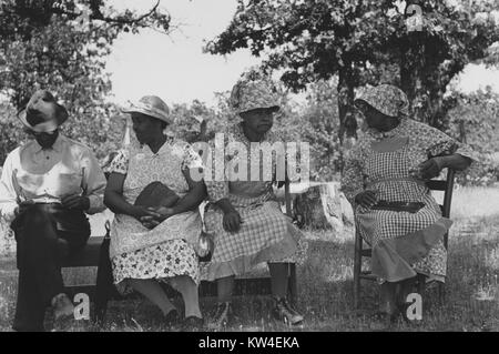 Senior African American women waiting outside a rural church while other members of their families are attending a church business meeting, McIntosh county, Oklahoma, USA, 1939. From the New York Public Library. () Stock Photo