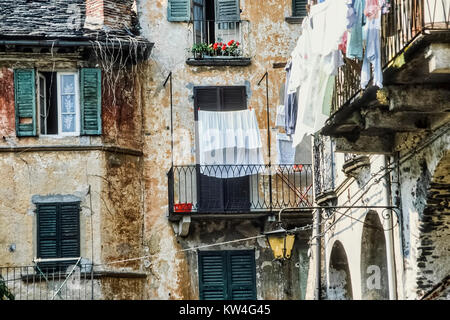 Characterful old backstreet with pootr housing and washing hanging from  poorly maintained balconiesin outskirts of Sorrento, Italy. Stock Photo