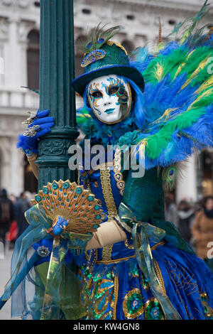 People at the Venice Carnival dressed in colourful costume and mask Stock Photo