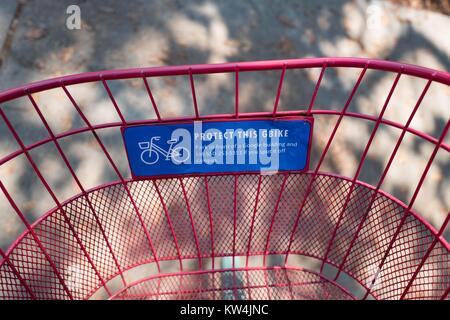Sign on the basket of a Google Bike (abbreviated as GBike) encouraging Google employees to protect the bike from theft by parking it in front of a Google building and reporting any sightings of the bike off-campus, at the Googleplex, headquarters of the search engine company Google in the Silicon Valley town of Mountain View, California, August 24, 2016. Employees are encouraged to ride the free bikes around Google's campus, and to leave them in front of Google buildings once they arrive at their destination, Mountain View, California. Stock Photo