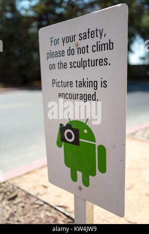 At the Googleplex, headquarters of the search engine company Google in the Silicon Valley town of Mountain View, California, a sign encourages visitors to take photographs of sculptures representing the Android cellphone operating system, but warns them against climbing on the sculptures, Mountain View, California, August 24, 2016. Stock Photo