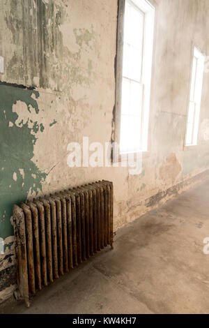 Pain pealing from walls and light streaming through an old window Stock Photo