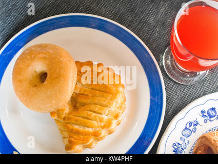 donut and bagel stuffed hot and steaming gold color ready for your breakfast or your own snack with glass of orange juice Stock Photo