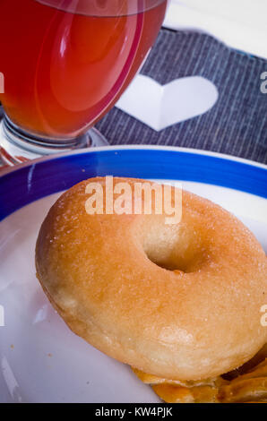 donut hot and steaming gold color ready for your breakfast or your own snack with glass of orange juice Stock Photo