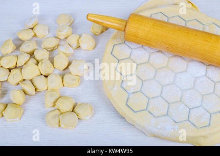 Preparation of pelmeni and dumplings at home in the kitchen for preparing, cooking, making homemade ravioli, pelmeni or dumplings with meat Stock Photo