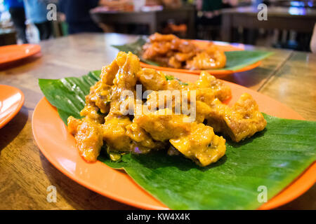 A chinese dish, salted-egg chicken at a local hawker centre. Stock Photo