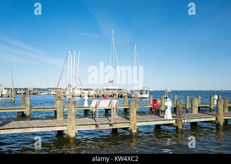 Dock with pilings, with sailboats in a marina visible in the background, on the Chesapeake Bay, Annapolis, Maryland, September 25, 2016. Stock Photo