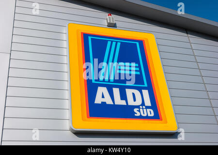 Aldi sign (south division) against blue sky. Aldi is a leading global discount supermarket chain with almost 10,000 stores in 18 countries. Stock Photo