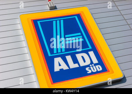 Aldi sign (south division) against blue sky. Aldi is a leading global discount supermarket chain with almost 10,000 stores in 18 countries. Stock Photo