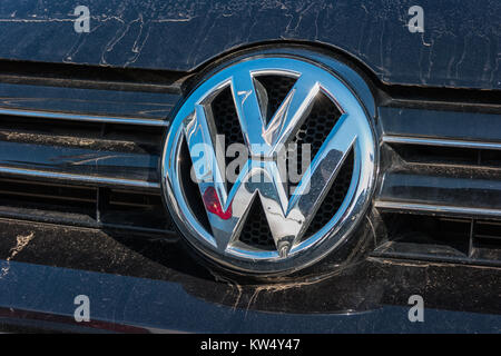 Dirty Sign of a Volkswagen logo on a car. Volkswagen is a company of the Volkswagen Group. Stock Photo