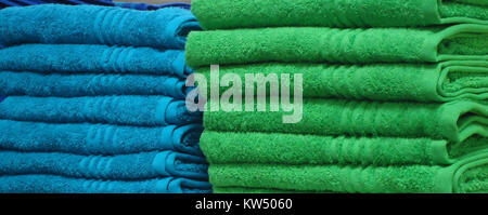 Blue and green towels on a shelf in a store in New Jersey Stock Photo