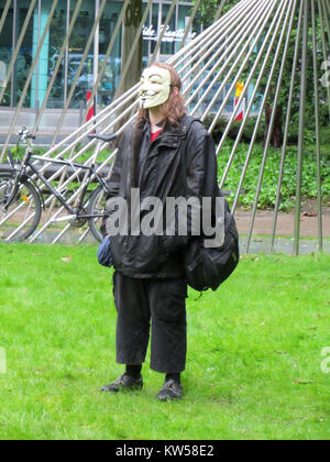 Pro Mask Sign March A demonstrator wearing a Guy Fawkes mask stands near the Arc de ...
