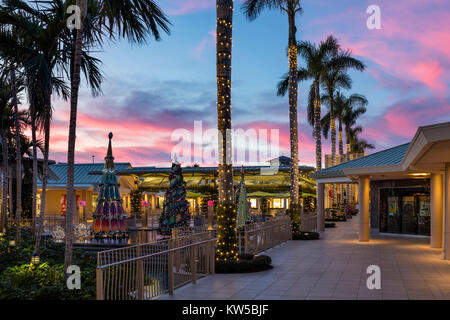 Christmas decorations and colorful sunset at the Waterside Shops - an upscale open-air mall, Naples, Florida Stock Photo