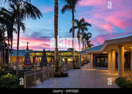 Christmas decorations and colorful sunset at the Waterside Shops - an upscale open-air mall, Naples, Florida Stock Photo