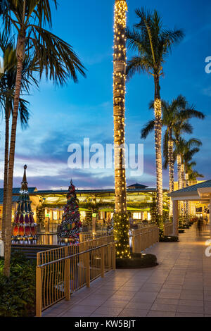 Christmas decorations and colorful sunset at the Waterside Shops - an upscale open-air mall, Naples, Florida Stock Photo