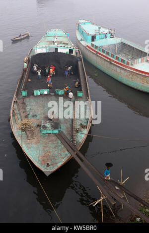 Bangladeshi workers unload coal from a ship in Dhaka. Stock Photo