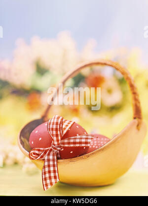 Easter background with eggs and spring flowers, shallow DOF, text space. This image is toned. Stock Photo