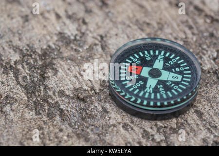 Button compass - metaphor business 'direction', navigation, moral compass, getting your bearings concept, orienteering + copy space. North direction Stock Photo