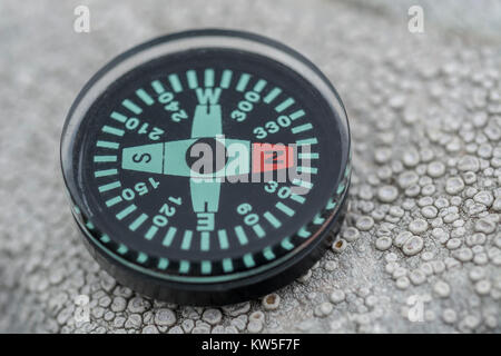 Button compass - metaphor for business 'direction', navigation, moral compass, getting your bearings concept, orienteering. Stock Photo