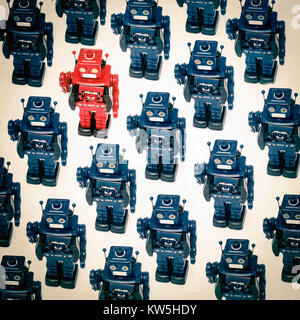 concept gong against the crowed with retro robot toys Stock Photo