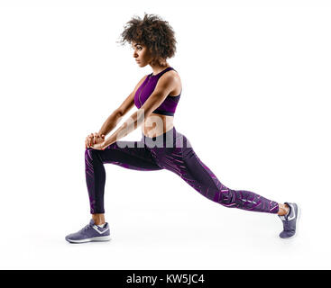 Fitness african girl doing stretching workout. Full length shot of young girl on white background. Stretching and motivation Stock Photo