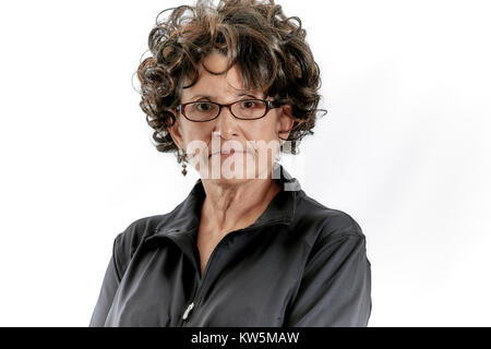 Middle aged woman with curly brown hair wearing eye glasses and smiling isolated on white Stock Photo