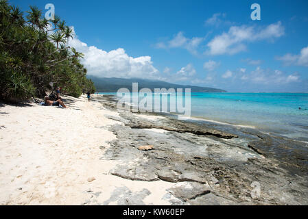 MYSTERY ISLAND, VANUATU, PACIFIC ISLANDS: DECEMBER 2,2016: Tourists relaxing on rocky shoreline and swimming in the sea at Mystery Island, Vanuatu Stock Photo