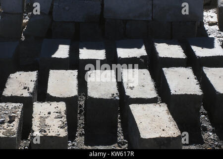 Gray bricks handmade, laid out in the sun to dry. Stock Photo