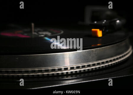 closeup of vinyl turntable, hi-fi headshell cartridge in action, Retro gramophone playing analog disc with music. place for text. Stock Photo