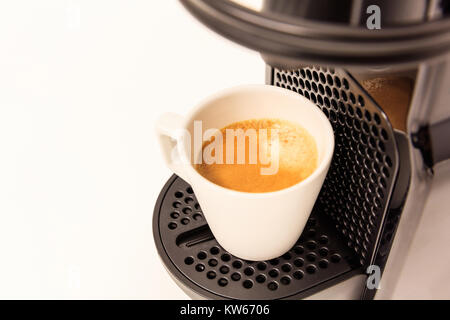 Espresso coffee maker machine. Ready coffee, modern design, white background, closeup view, details. Stock Photo