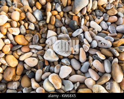 A close up section of pebbles on a beach covered in a heavy frost Stock Photo