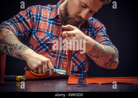 Professional Tanner working with leatherwork Stock Photo