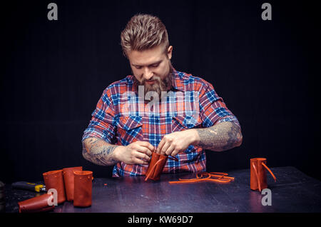 Leather workman creates quality product of leather in his shop Stock Photo