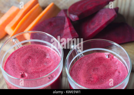 glass of fresh beet and carrot juice on wooden table Stock Photo