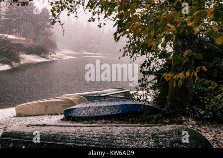 first snow on lake boats Stock Photo