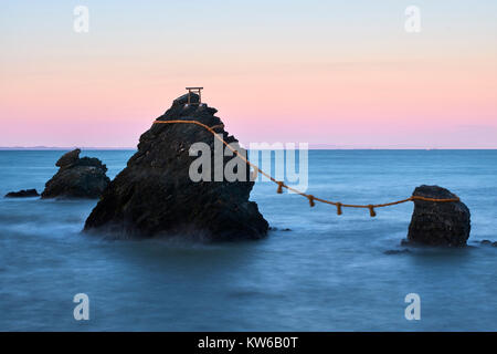 Japan, Honshu island, Ise Shima, Mie region, Futami, Meoto-Iwa (Wedded Rocks), two rocks considered to be male and female, joined in matrimony by shim Stock Photo