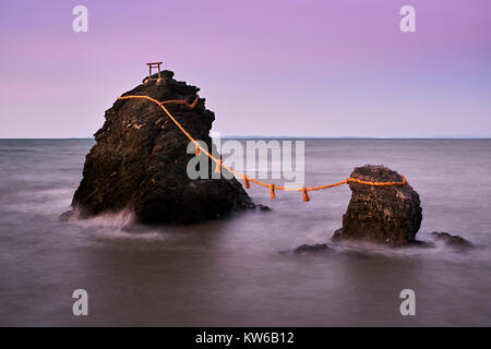 Japan, Honshu island, Ise Shima, Mie region, Futami, Meoto-Iwa (Wedded Rocks), two rocks considered to be male and female, joined in matrimony by shim Stock Photo