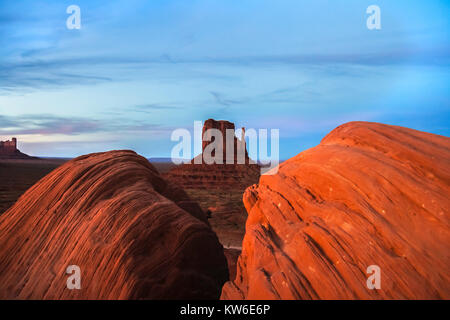 Classic view of the West Mitten Butte with sandstone rocks in the foreground in Monument Valley Navajo Tribal Park at dusk, Arizona, USA. Stock Photo