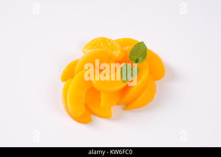 peeled and sliced peaches on white background Stock Photo