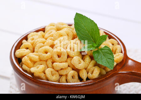 saucepan of honey cereal rings - close up Stock Photo