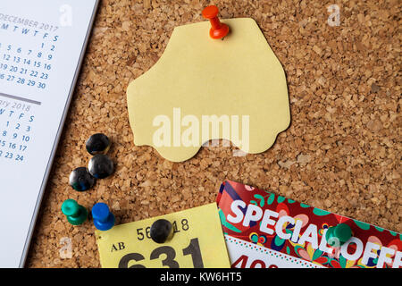 Blank car shaped Note on cork notice board with red pin Stock Photo
