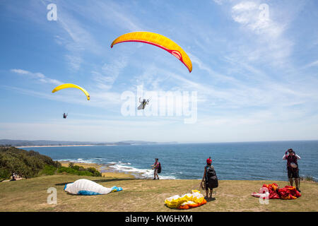 People paragliding and hang gliding at long reef point, Long Reef acquatic reserve,Sydney,Australia Stock Photo