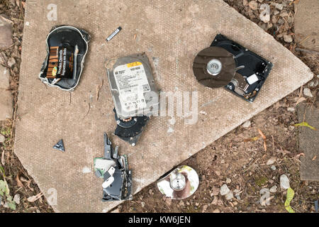 A broken hard disk drive HDD on the ground. Stock Photo