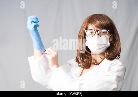 Great concept of medicine, young nurse putting on the gloves. Stock Photo