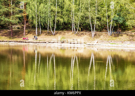 Cyclists relax at the pond, birch trees Czech Republic Stock Photo